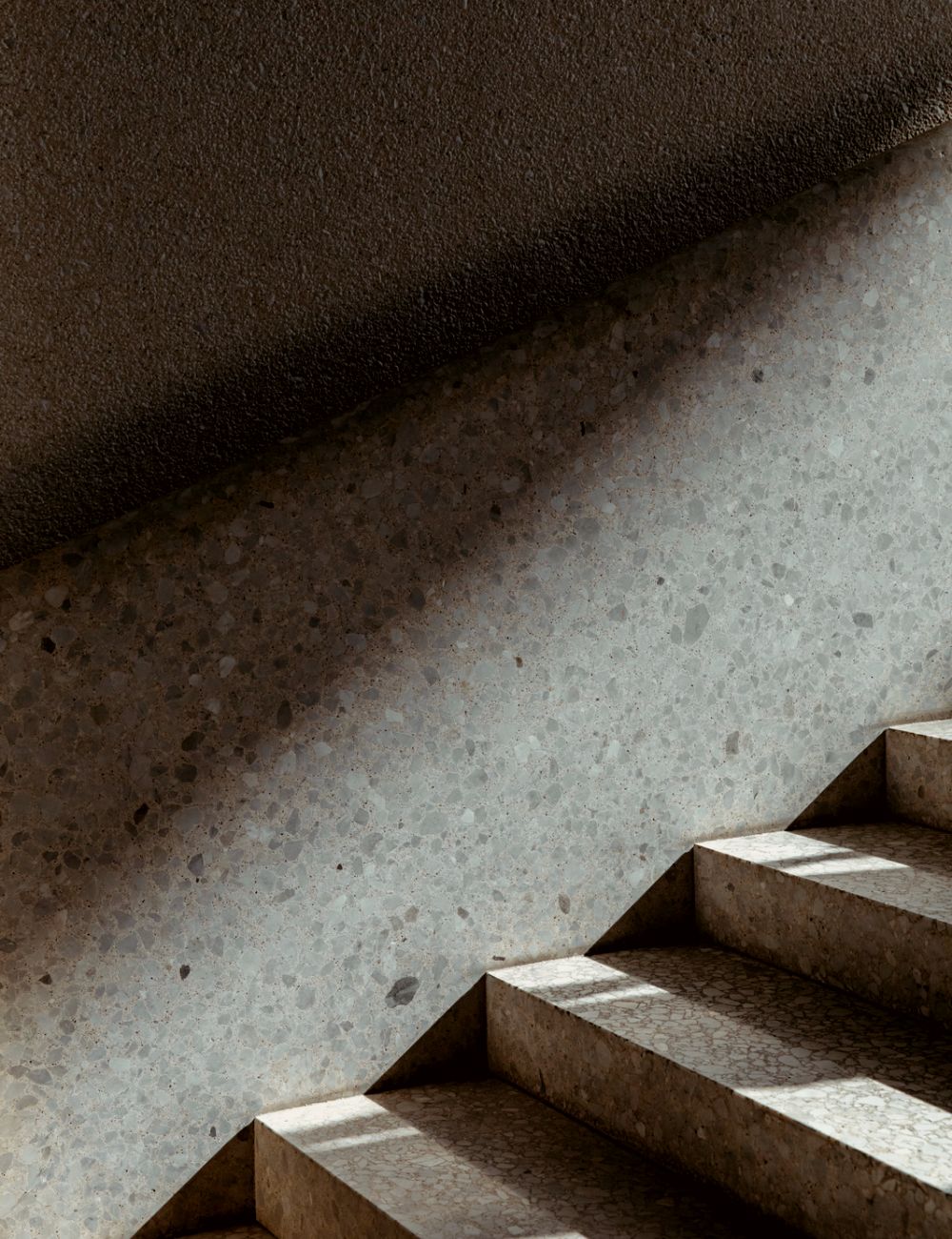 A dark staircase is illuminated by light.