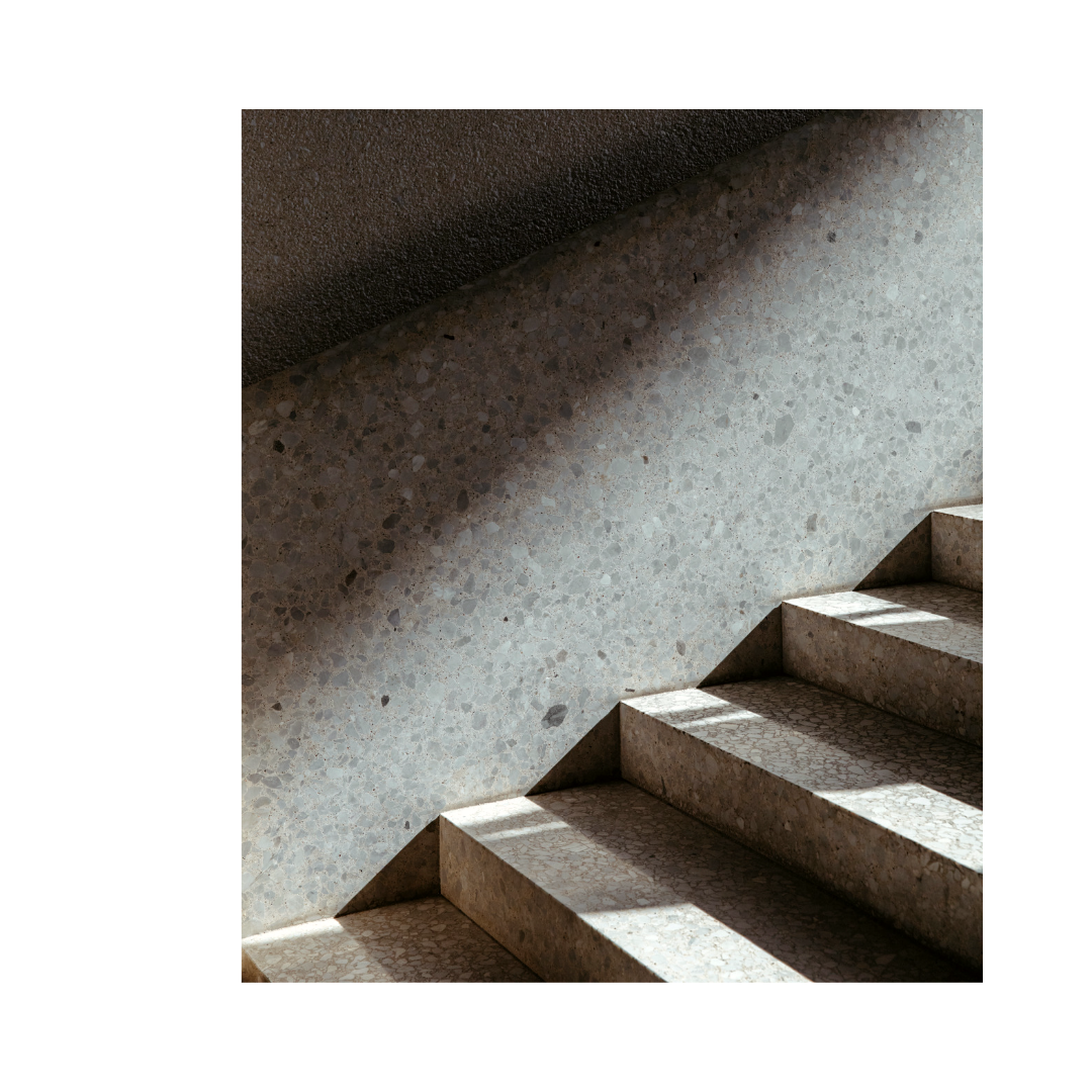 A dark staircase is illuminated with light.