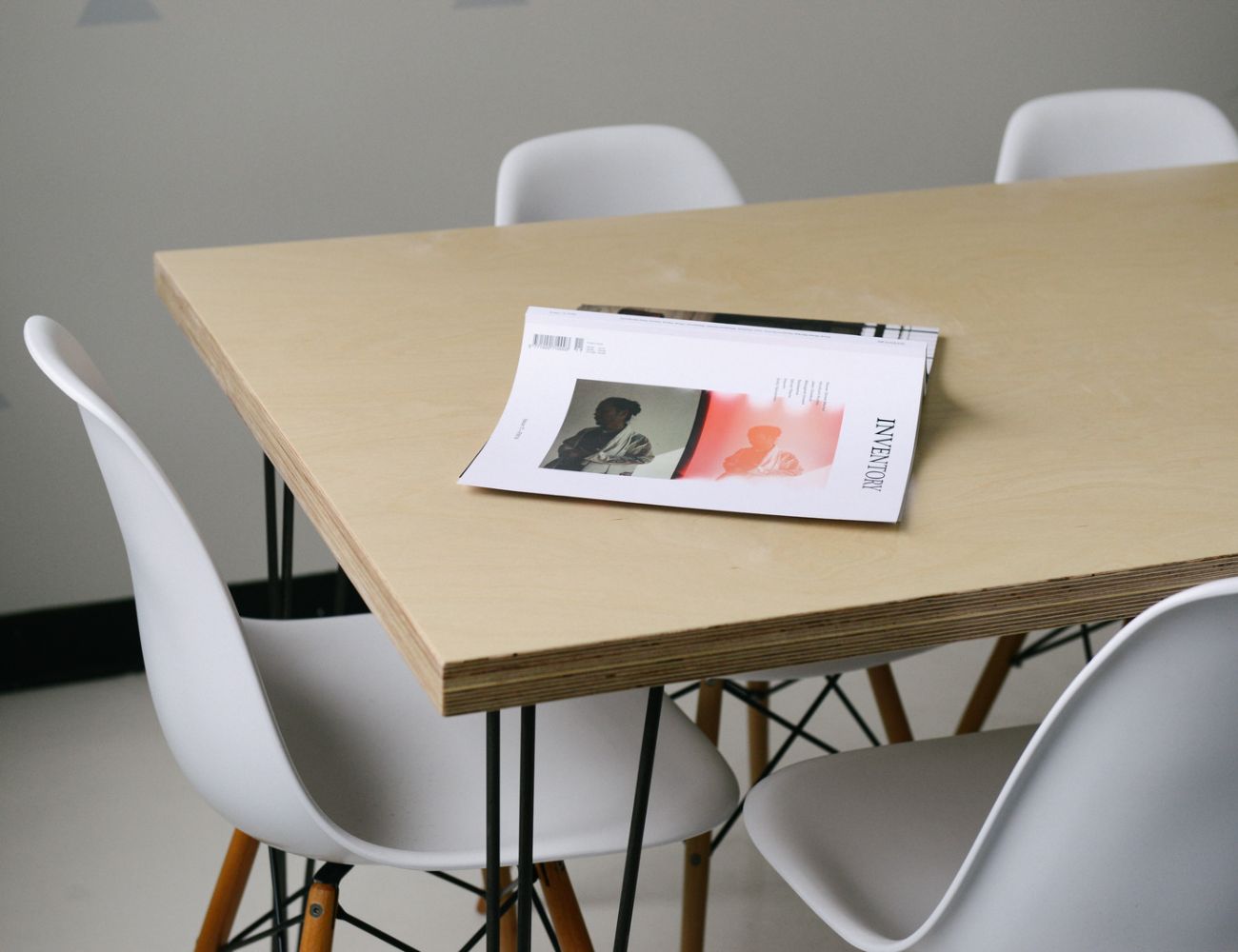 An open journal sits a top a conference room table.